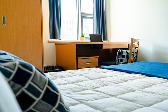 Double bed with desk by the window