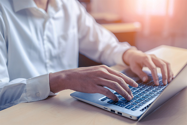 Event host typing on computer