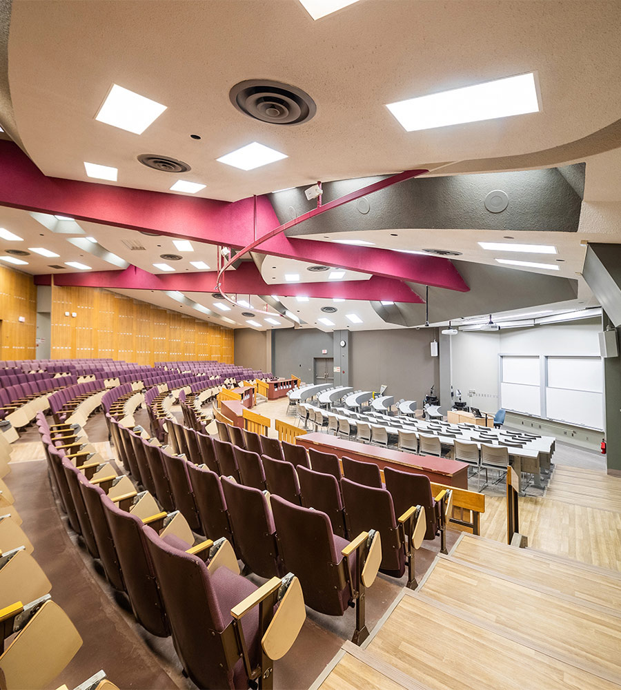 Lecture style classroom with fixed tables and chairs