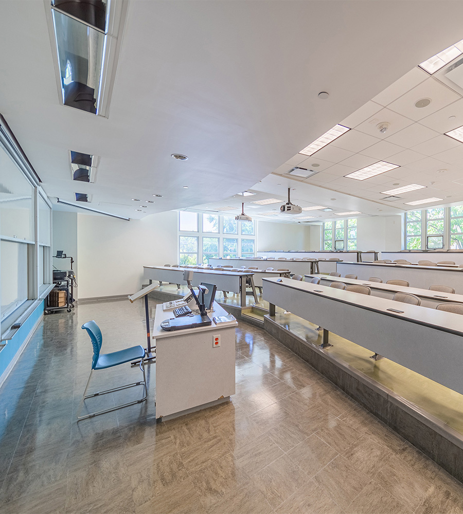 Lecture style classroom with fixed tables and chairs