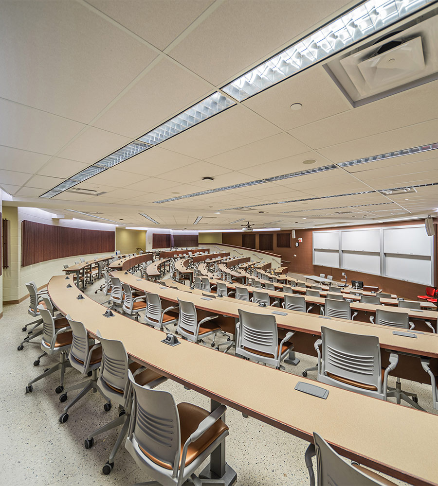 Lecture style classroom with fixed tables and chairs